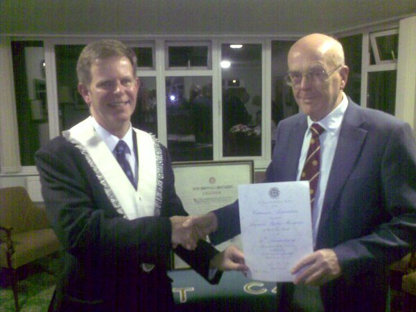 Steve Hardgrave receives scroll from David Brinkley.