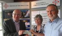 Paul Kennedy presenting cheque to FHL GM Sean Higgins